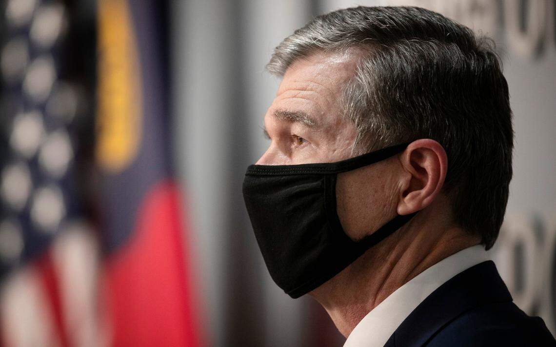 North Carolina Governor Roy Cooper listens to Dr. Mandy Cohen, Secretary of the North Carolina Department of Health and Human Services during a press briefing on Thursday, September 17, 2020 at the Emergency Operations Center in Raleigh, N.C.