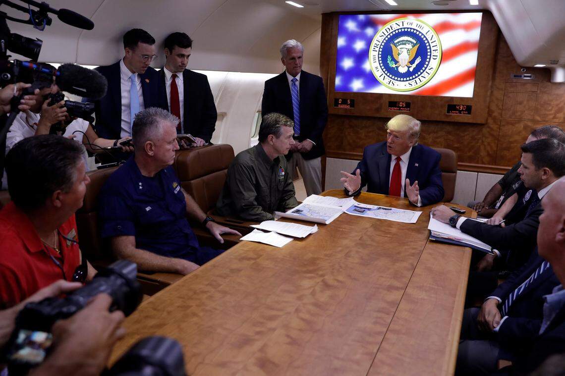 President Donald Trump participates in a briefing with North Carolina Gov. Roy Cooper, left, and House Minority Leader Kevin McCarthy of Calif., standing center, about Hurricane Dorian at Marine Corps Air Station Cherry Point, Monday, Sept. 9, 2019, in Havelock, N.C., aboard Air Force One.