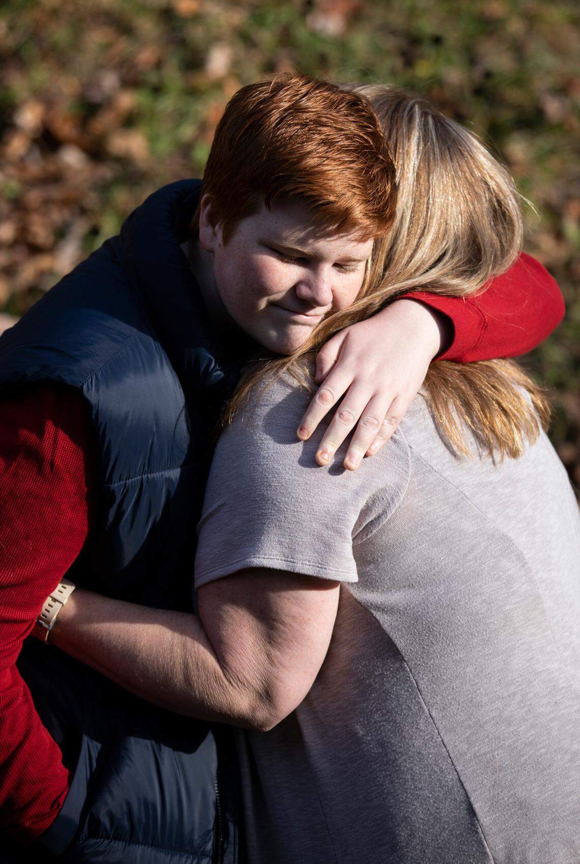 Quinn Wilson, 13, hugs his mother Lindsay Wilson outside their home in Newland, N.C. on Monday, Nov. 29, 2021.