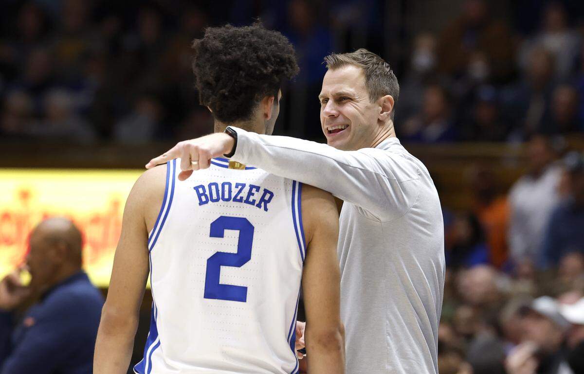 Duke head coach Jon Scheyer talks to Cayden Boozer (2) during the second half of Duke’s 101-64 victory over Syracuse at Cameron Indoor Stadium in Durham, N.C., Monday, Feb. 16, 2026.