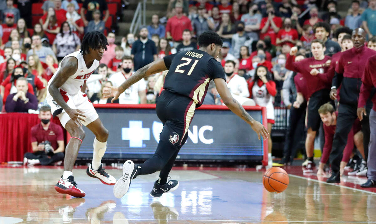Florida State’s Cam’Ron Fletcher (21) steals the inbound pass intended for N.C. State’s Dereon Seabron (1) with eight seconds left in the game during Florida State’s 83-81 victory over N.C. State at PNC Arena in Raleigh, N.C., Saturday, Jan. 1, 2022.