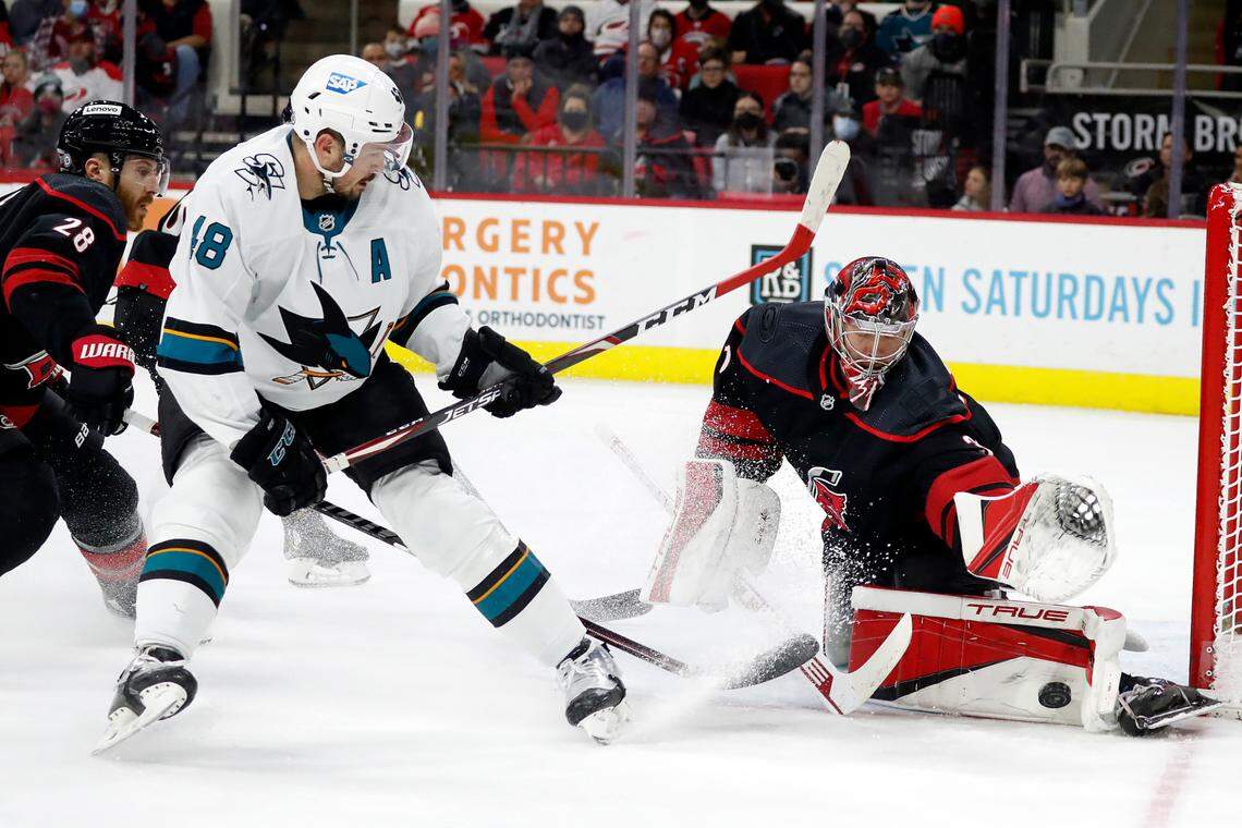 Carolina Hurricanes goaltender Frederik Andersen, right, blocks the shot of San Jose Sharks’ Tomas Hertl (48) during the first period of an NHL hockey game in Raleigh, N.C., Sunday, Jan. 30, 2022. (AP Photo/Karl B DeBlaker)