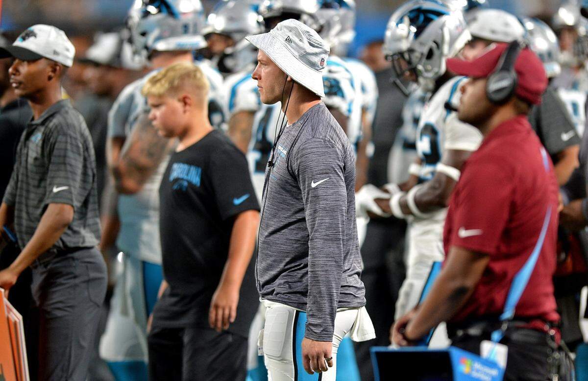 Carolina running back Christian McCaffrey, center in hat, was healthy throughout the preseason but never played a snap as the Panthers tried hard to keep him from getting hurt.