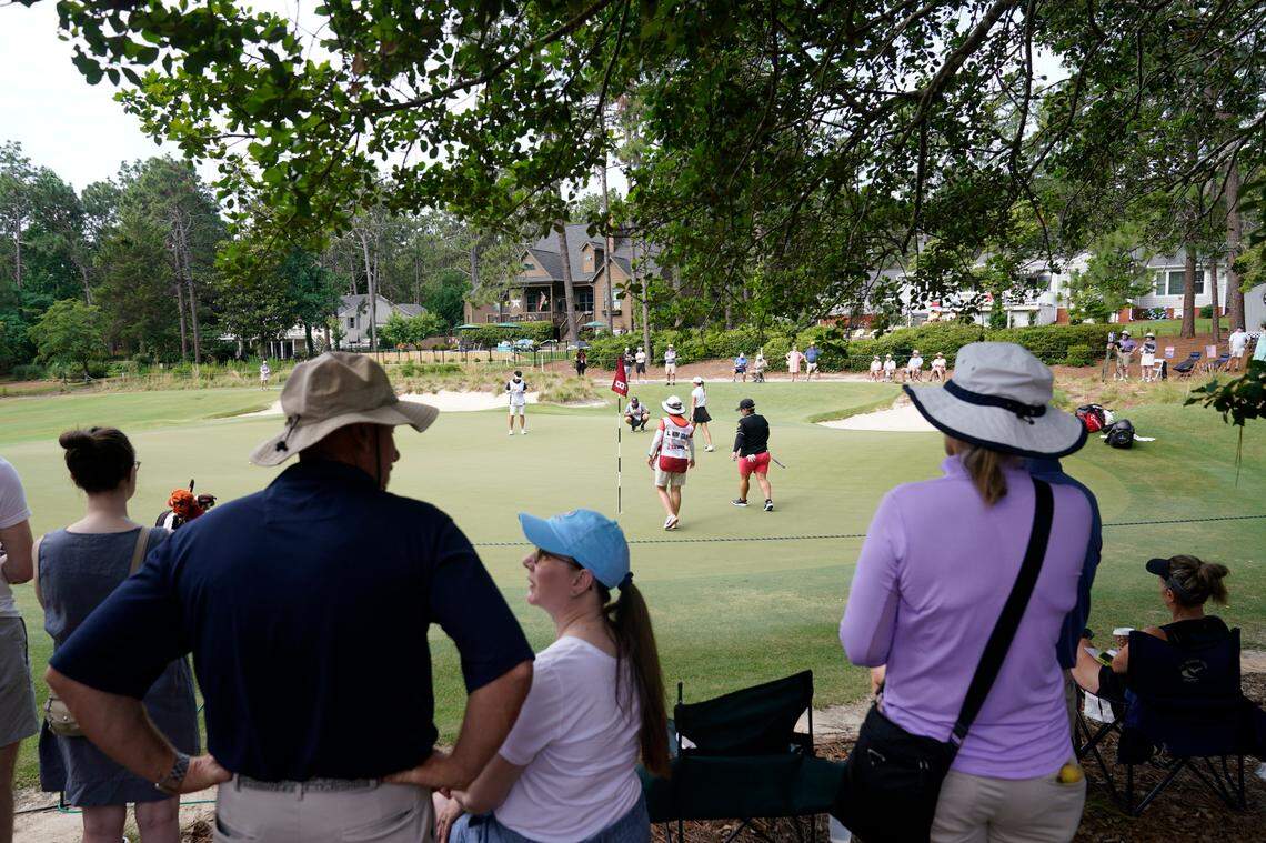 Fans watch as golfers look over the eighth green during the final round of the U.S. Women’s Open golf tournament at the Pine Needles Lodge & Golf Club in Southern Pines, N.C., on Sunday, June 5, 2022.