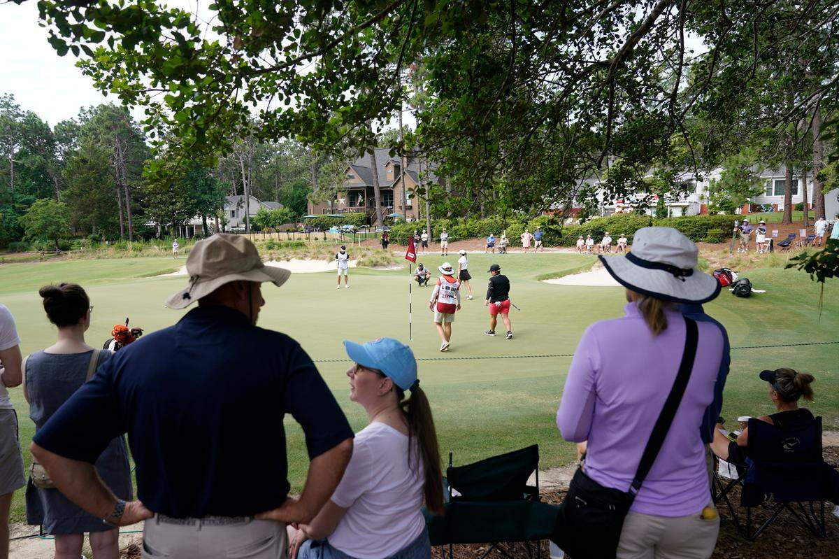 Fans watch as golfers look over the eighth green during the final round of the U.S. Women’s Open golf tournament at the Pine Needles Lodge & Golf Club in Southern Pines, N.C., on Sunday, June 5, 2022.