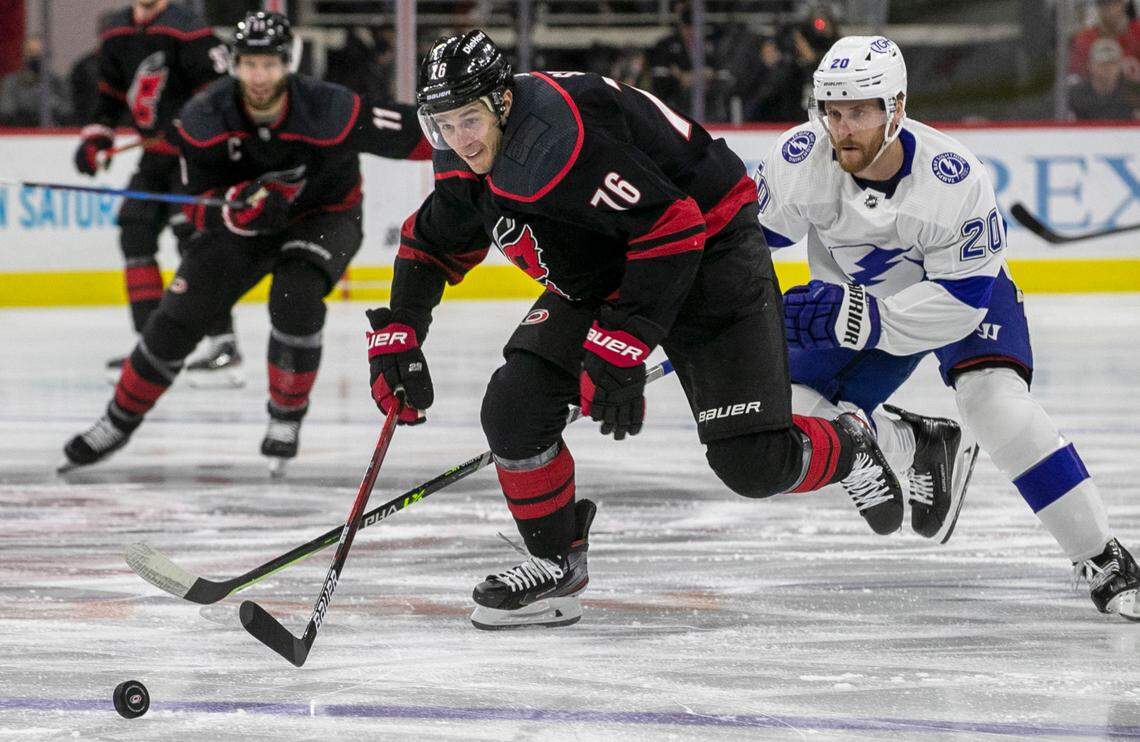 Carolina Hurricanes Brady Skjei (76) chases down the puck ahead of Tampa Bay’s Blake Coleman (20) during the first period of their second round Stanley Cup series on Tuesday, June 1, 2021 at PNC Arena in Raleigh, N.C.