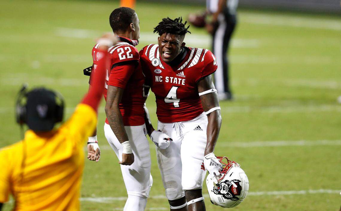 N.C. State’s Cecil Powell (4) celebrates with Teshaun Smith (22) after Wake Forest turned the ball over on downs during the second half of N.C. State’s 45-42 victory over Wake Forest at Carter-Finley Stadium in Raleigh, N.C, Saturday, Sept. 19, 2020.