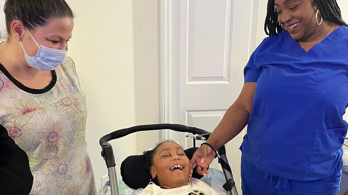 Home health care nurse Jessica Britton (left) with Salana and her mother, Shatara Woodley.