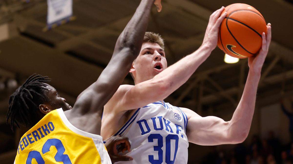 Duke’s Kyle Filipowski is fouled while driving to the basket past Pittsburgh’s Federiko Federiko during the first half of a men’s basketball game at Cameron Indoor Stadium on Wednesday, Jan. 11, 2023, in Durham, N.C.