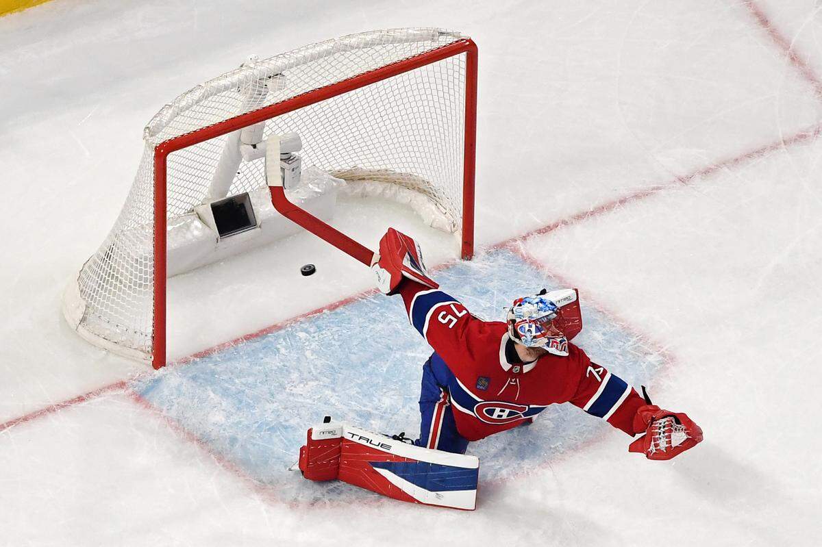 Jakub Dobes #75 of the Montreal Canadiens gives up a goal scored by Logan Stankoven #22 of the Carolina Hurricanes during the first period in Game Four of the Eastern Conference Final of the 2026 Stanley Cup Playoffs at Bell Centre on May 27, 2026 in Montreal, Quebec, Canada. 