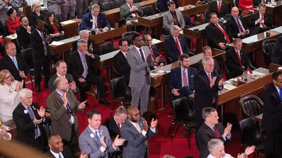Most Democratic legislators stand as Gov. Roy Cooper talks about expanding Medicaid during the biennial State of the State address to a joint session of the General Assembly at the Legislative Building Monday evening, Feb. 26, 2019.