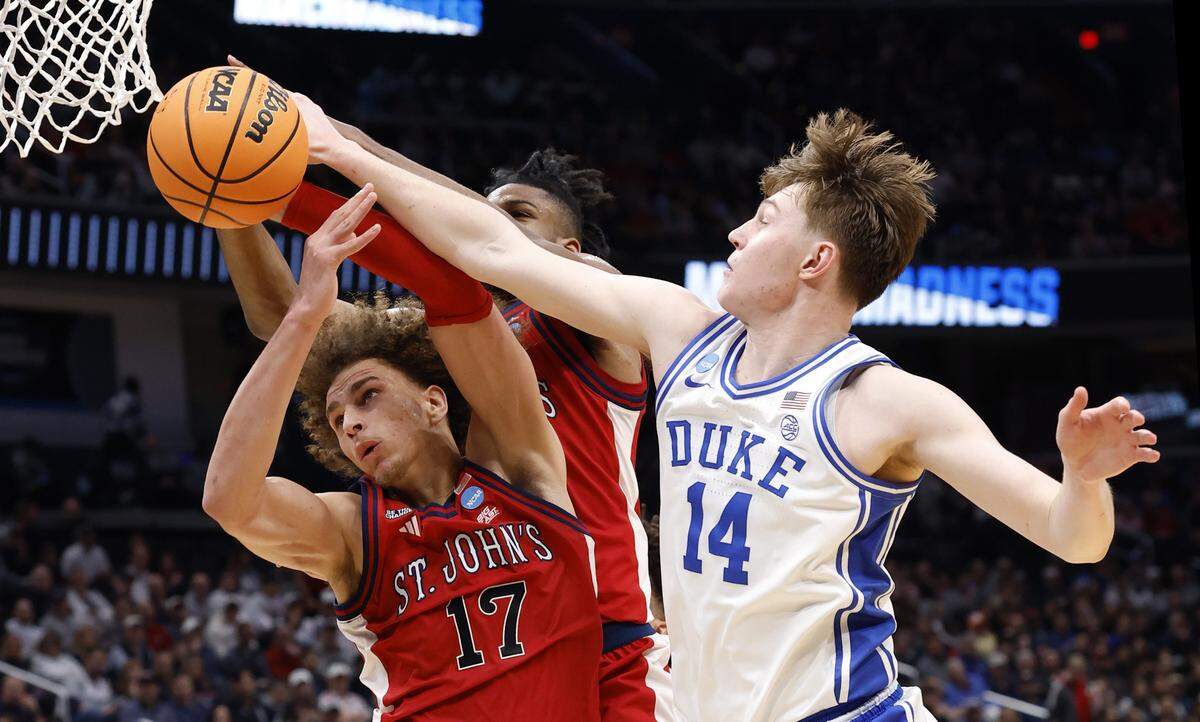 Duke’s Nikolas Khamenia (14) and St. John's Rubén Prey (17) go for the ball during the first half of Duke’s game against St. John’s in the Sweet 16 of the NCAA Men’s Basketball East Regional at Capital One Arena in Washington, D.C., Friday, March 27, 2026.