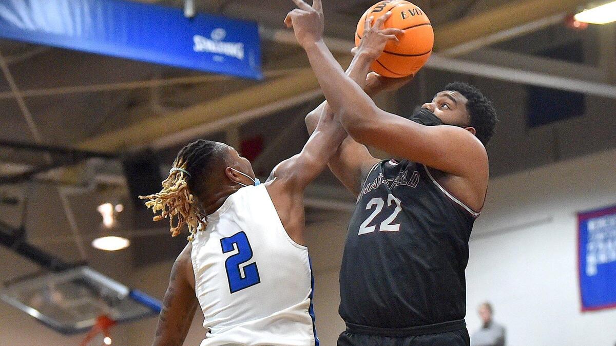 Wake Forest’s Dashaun Grant (2) blocks the shot from Wakefield’s Zach Weed (22) during the second half. The Wakefield Wolverines and the Wake Forest Cougars met in a conference basketball game in Wake Forest, NC on January 14, 2022.