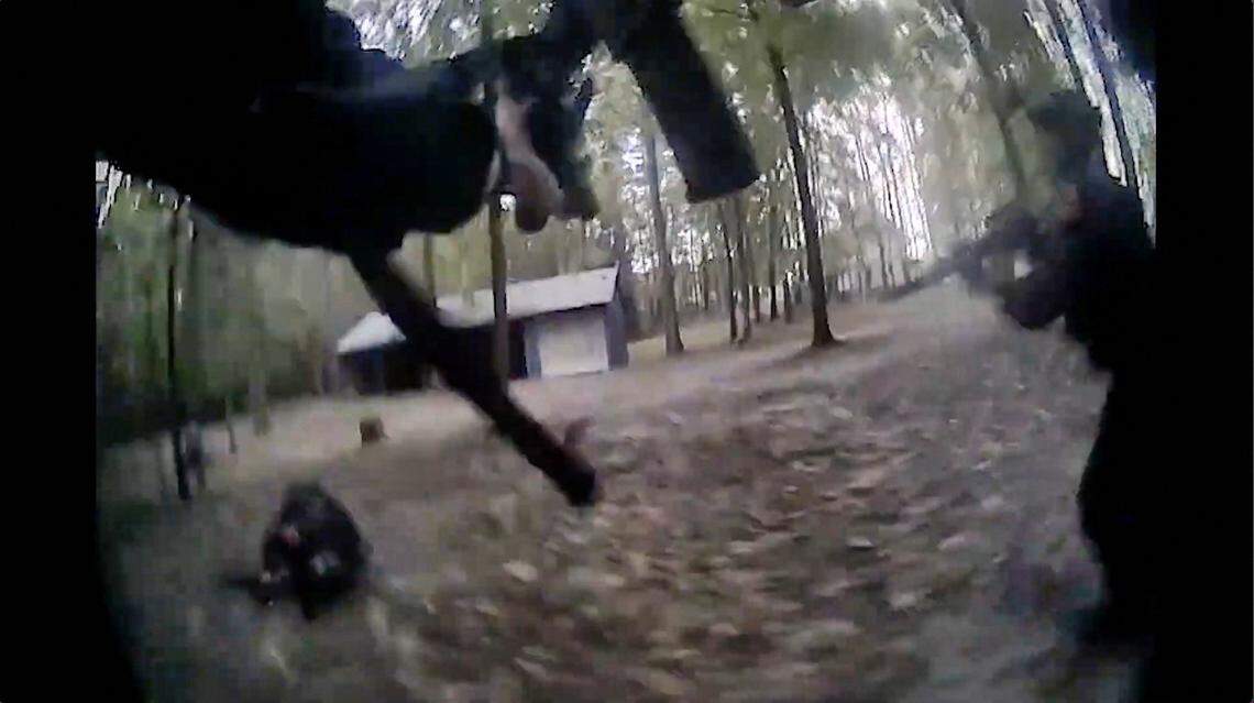 A screen grab of body camera footage shows Raleigh police officers during an encounter with Austin Thompson that resulted in one officer being shot in the leg.