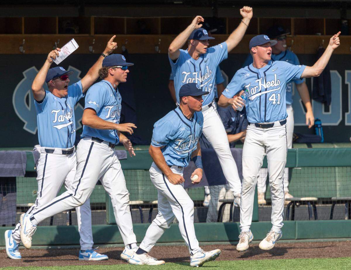 North Carolinas Eric Grintz (5) and his teammates react after a diving catch by Vance Honeycutt on a long ball by Arkansas Brady Slavens in the seventh inning in game two of their NCAA Super Regional series on Sunday, June 12, 2022 at Boshamer Stadium in Chapel Hill, N.C.