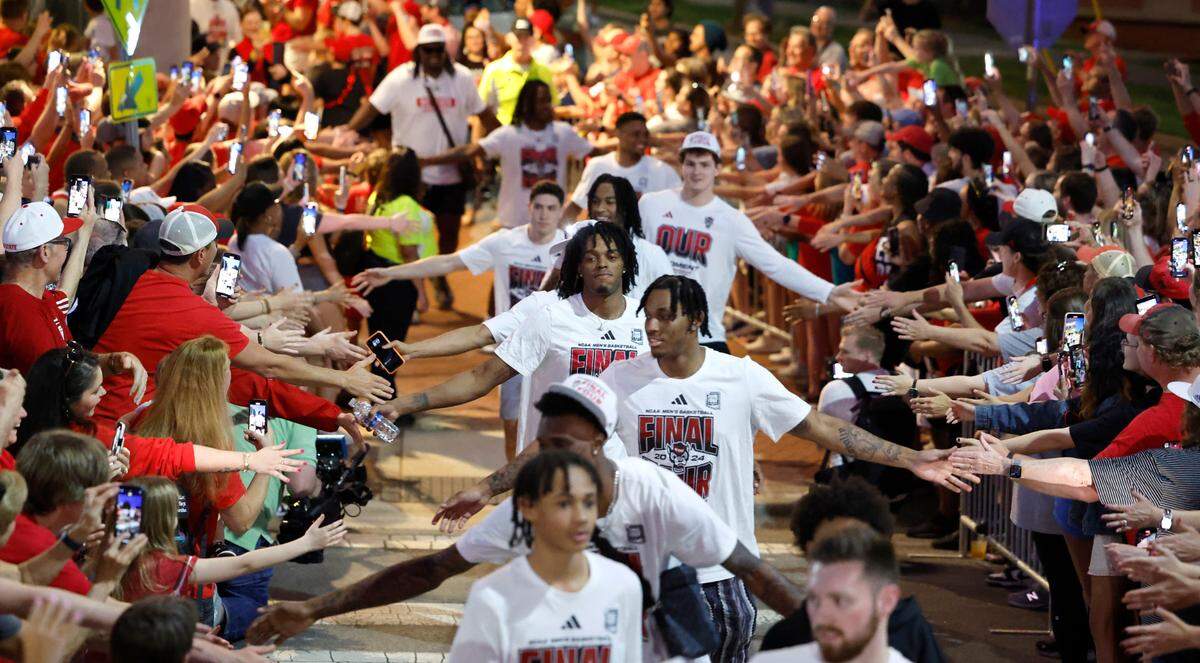 The men’s basketball team greets fans as they walk to the belltower during a celebration for the N.C. State men’s and women’s basketball team at the Memorial Belltower in Raleigh, N.C., Monday, April 15, 2024. Both teams made it to the NCAA Tournament Final Four, the first time both did it in the same season.