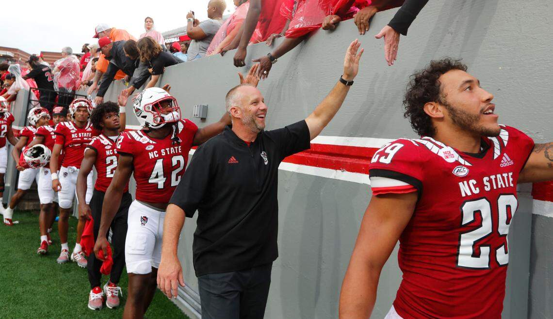 N.C. State head coach Dave Doeren greets fans after N.C. State’s 55-3 victory over Charleston Southern at Carter-Finley Stadium in Raleigh, N.C., Saturday, Sept. 10, 2022.