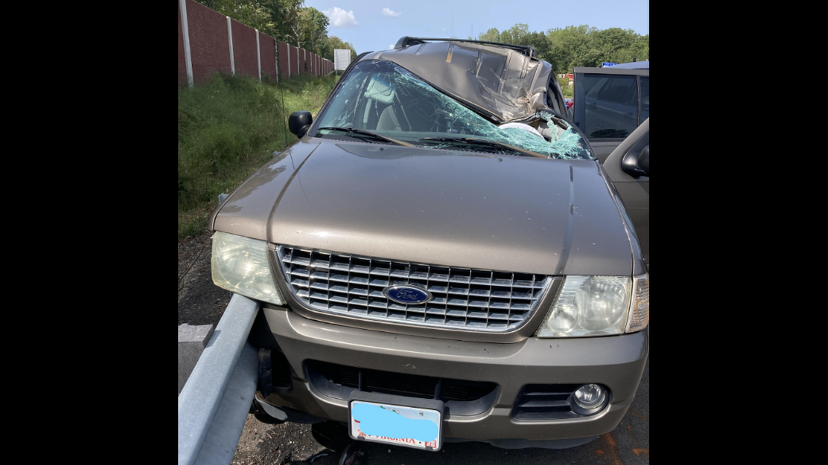 A photo shared by Virginia State Police shows the driver’s side of the roof collapsed under the weight of the flying Jeep tire.