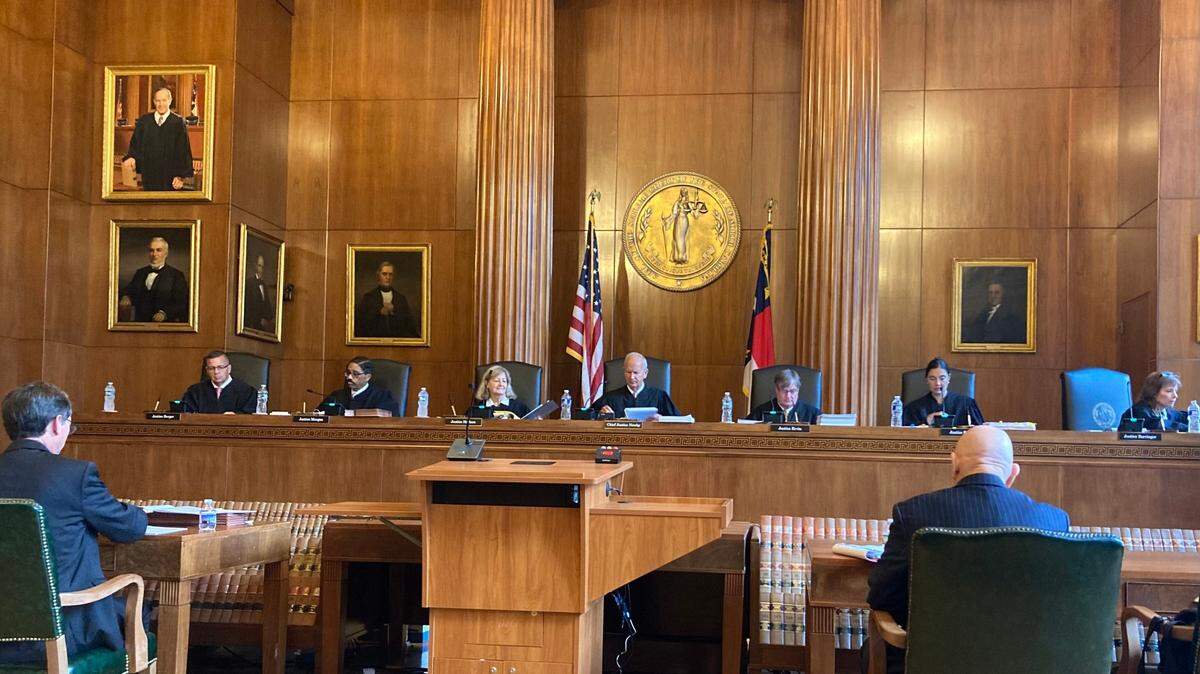 The North Carolina Supreme Court prepares to hear a case on Winston-Salem’s 2019 removal of a Confederate monument, on Aug. 29, 2022, in Raleigh. From left, the justices are Phil Berger Jr., Michael Morgan, Robin Hudson, Paul Newby, Sam Ervin IV, Anita Earls and Tamara Barringer.