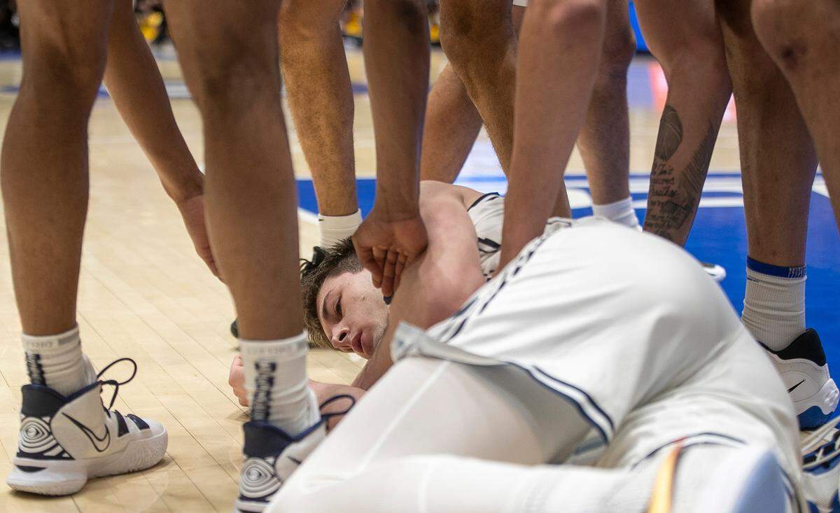 Duke’s Kyle Filipowski (30) is surrounded by teammates after taking a hard fall in the second half against North Carolina on Saturday, February 4, 2023 at Cameron Indoor Stadium in Durham, N.C.