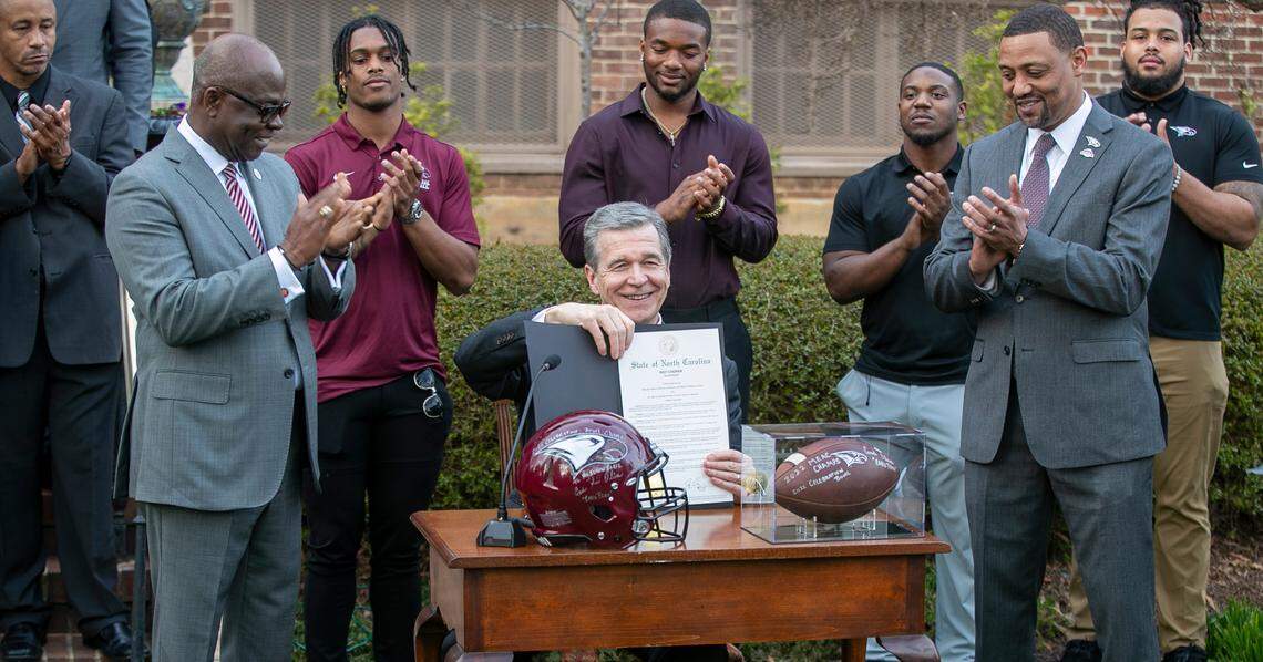 North Carolina Governor Roy Cooper signs a proclamation honoring the honoring the North Carolina Central University football team’s 2022 HBCU National Championship, during a reception on Wednesday, February 15, 2023 in Raleigh, N.C.