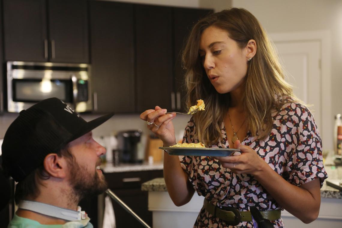 Sarah Santoro Thor blows on her husband’s eggs before feeding him in their downtown Raleigh apartment on July 1, 2019. The couple who have thrived on leading physically active and separate lives have now had to learn how to live a new life together after Michael Thor’s motorcycle accident.