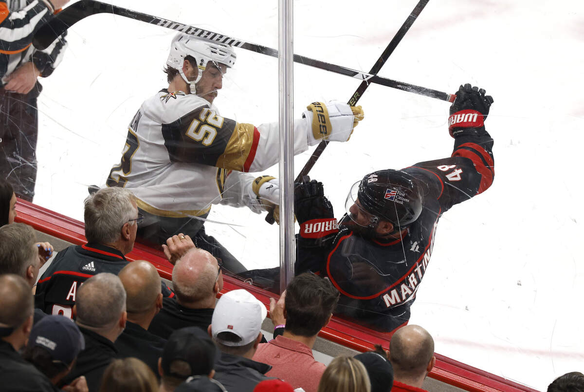 Vegas’ Dylan Coghlan (52) checks Carolina's Jordan Martinook (48) in the first period of the Hurricanes’ game against the Golden Knights in the first game of the Stanley Cup Final at the Lenovo Center in Raleigh, N.C., Tuesday, June 2, 2026.