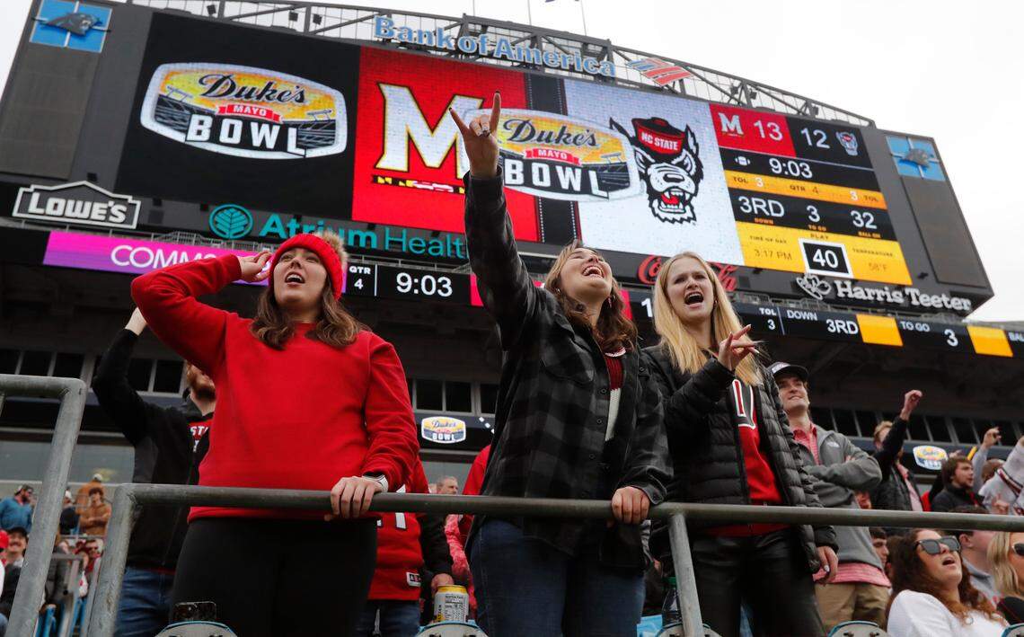 Fans cheer on the Wolfpack during the second half of Maryland’s 16-12 victory over N.C. State in the Duke’s Mayo Bowl at Bank of America Stadium in Charlotte, N.C., Friday, Dec. 30, 2022.