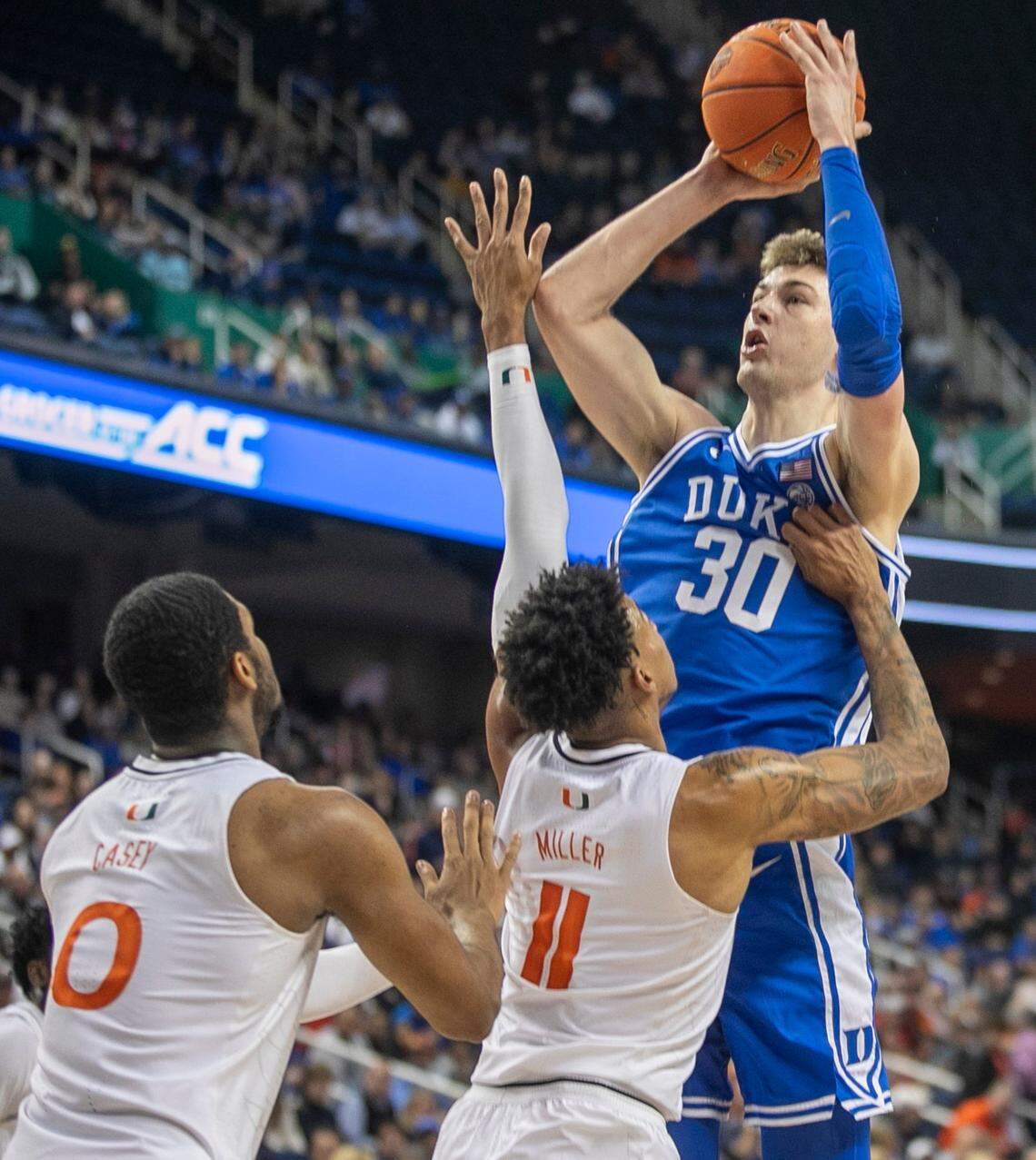 Duke’s Kyle Filipowski (30) puts up a shot against Miami’s Jordan Miller (11) in the first half during in the semi-finals of the ACC Tournament on Friday, March 10, 2023 at the Greensboro Coliseum in Greensboro, N.C.