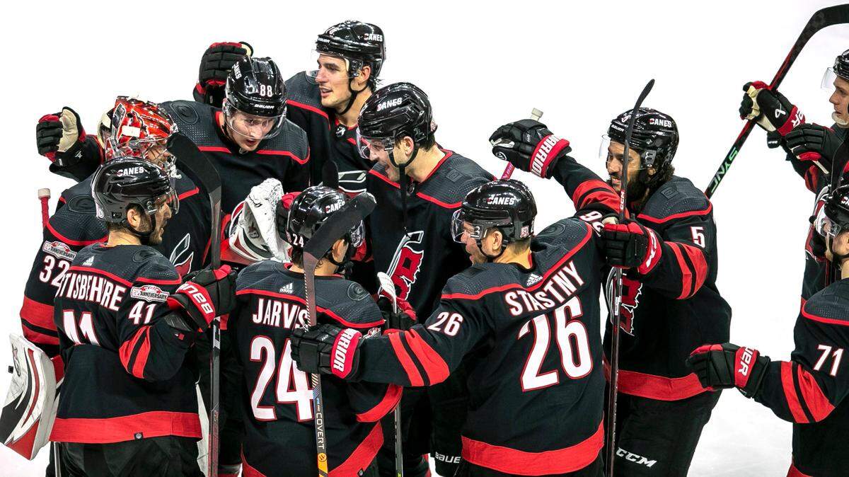 Carolina’s Hurricanes’ Martin Necas (88) is surrounded by teammates after scoring the game winning goal in over time to secure a 3-2 victory over Ottawa on Tuesday, April 4, 2023 at PNC Arena in Raleigh, N.C.