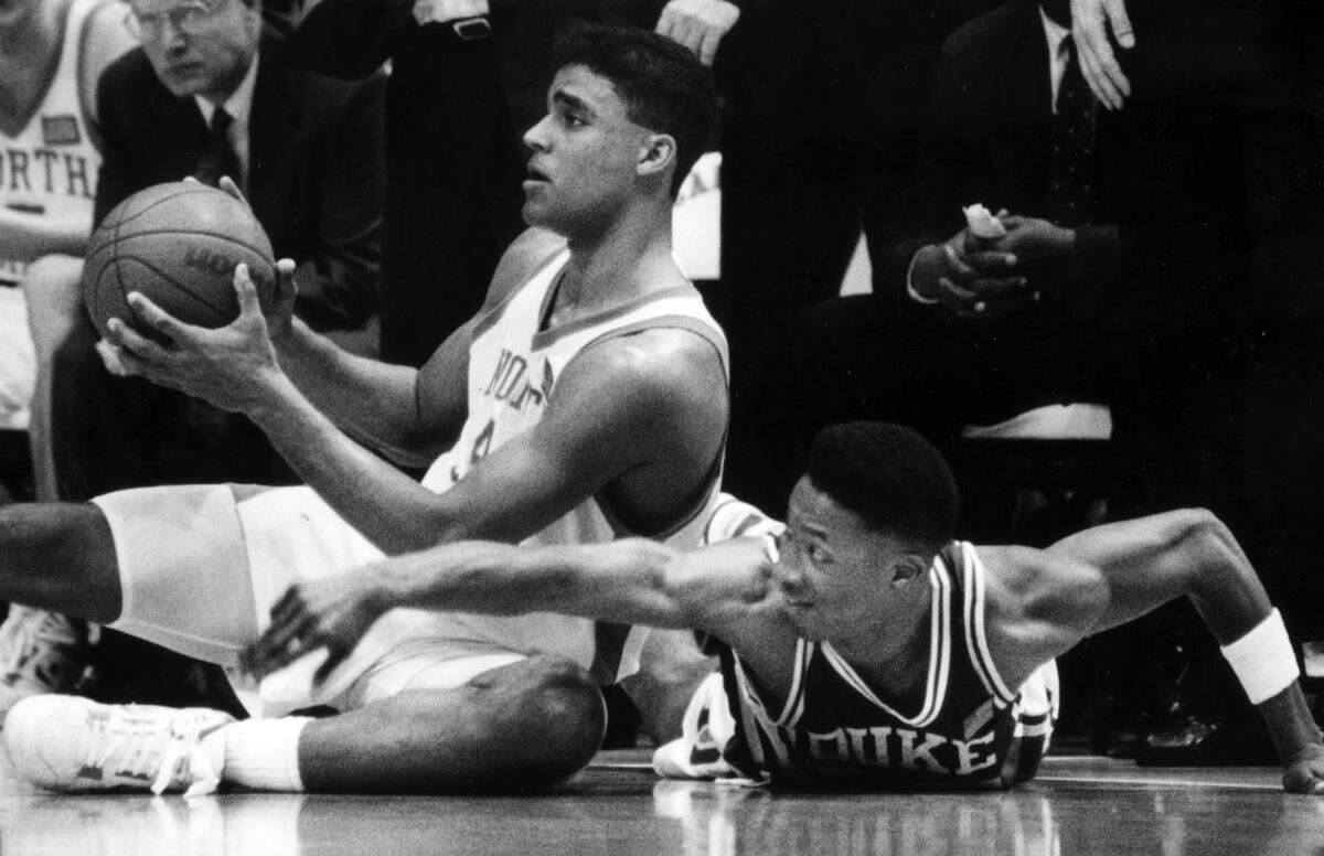 North Carolina’s Rick Fox grabs a loose ball against Duke in 1991.