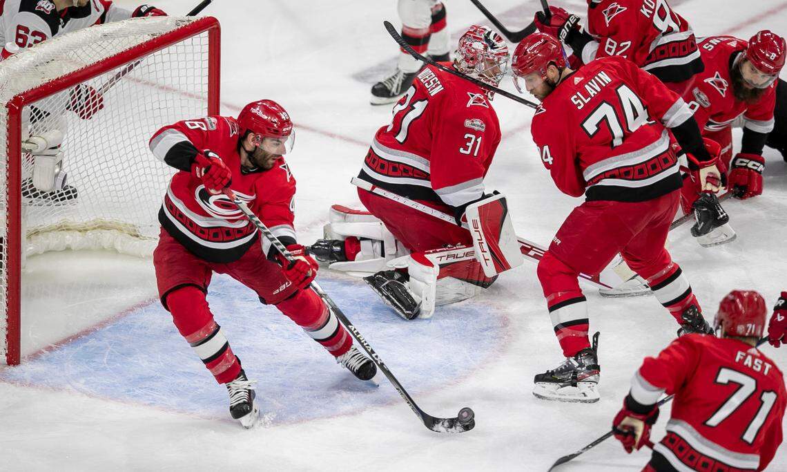 The Carolina Hurricanes Jordan Martinook (48) clears the puck from the crease in front of goalie Frederik Andersen (31) in the second period during Game 1 of their second round Stanley Cup playoff series against the New Jersey Devils on Wednesday, May 3, 2023 at PNC Arena in Raleigh, N.C.