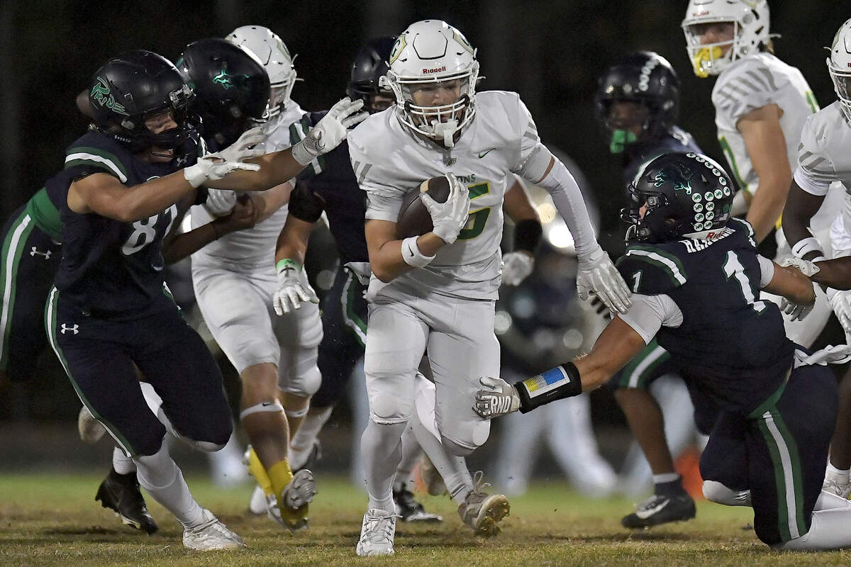 Cardinal Gibbons wide receiver Hudson van Dyke (15) rushes for yards against Leesville Road’s Walker Hakerem (1) and Adam Sonye (81) during the first half. The Leesville Road Pride and the Cardinal Gibbons Crusaders met in a conference football game in Raleigh, N.C. on November 1, 2024.