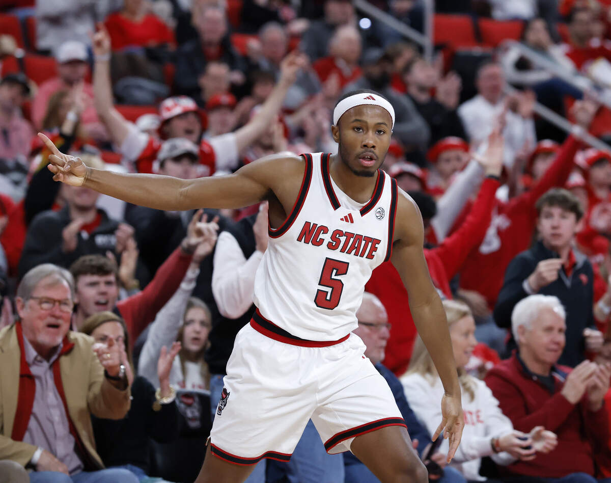 N.C. State’s Tre Holloman reacts after knocking down a three-point basket during the second half of the Wolfpack’s 82-73 win over Virginia Tech on Saturday, Feb. 7, 2026 at Lenovo Center in Raleigh, N.C. 