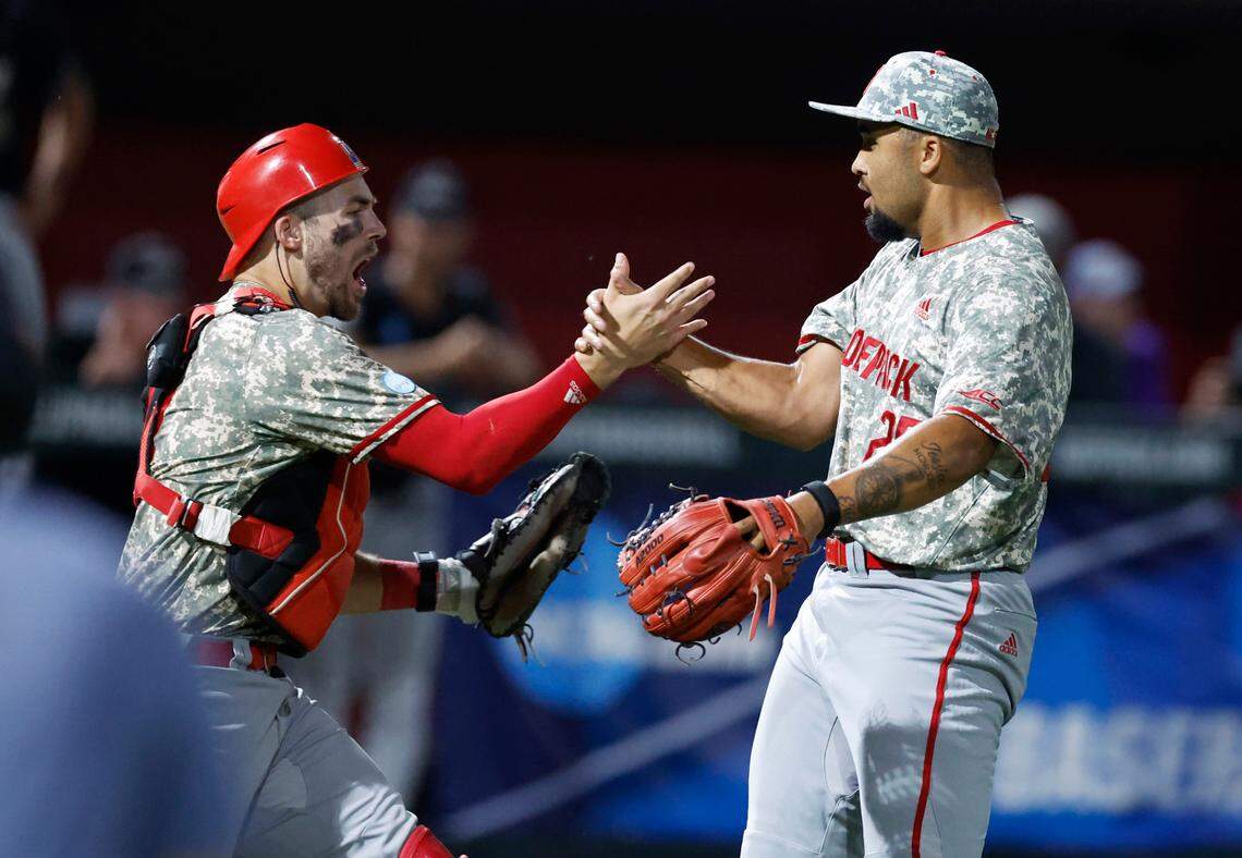 N.C. State’s Jacob Cozart (14) celebrates with Derrick Smith (25) after N.C. State’s 5-3 victory over James Madison in the NCAA Raleigh Regional final at Doak Field Sunday, June 2, 2024.