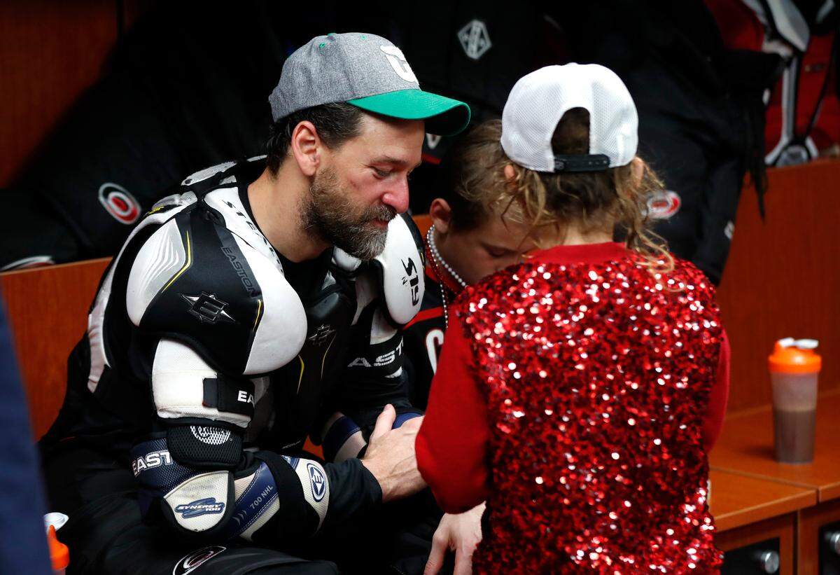Carolina’s Justin Williams sits in the locker room with his kids Jaxon and Jade after the Boston Bruins eliminated the Carolina Hurricanes in game four of the Eastern Conference finals at PNC Arena in Raleigh, N.C. Thursday, May 16, 2019.