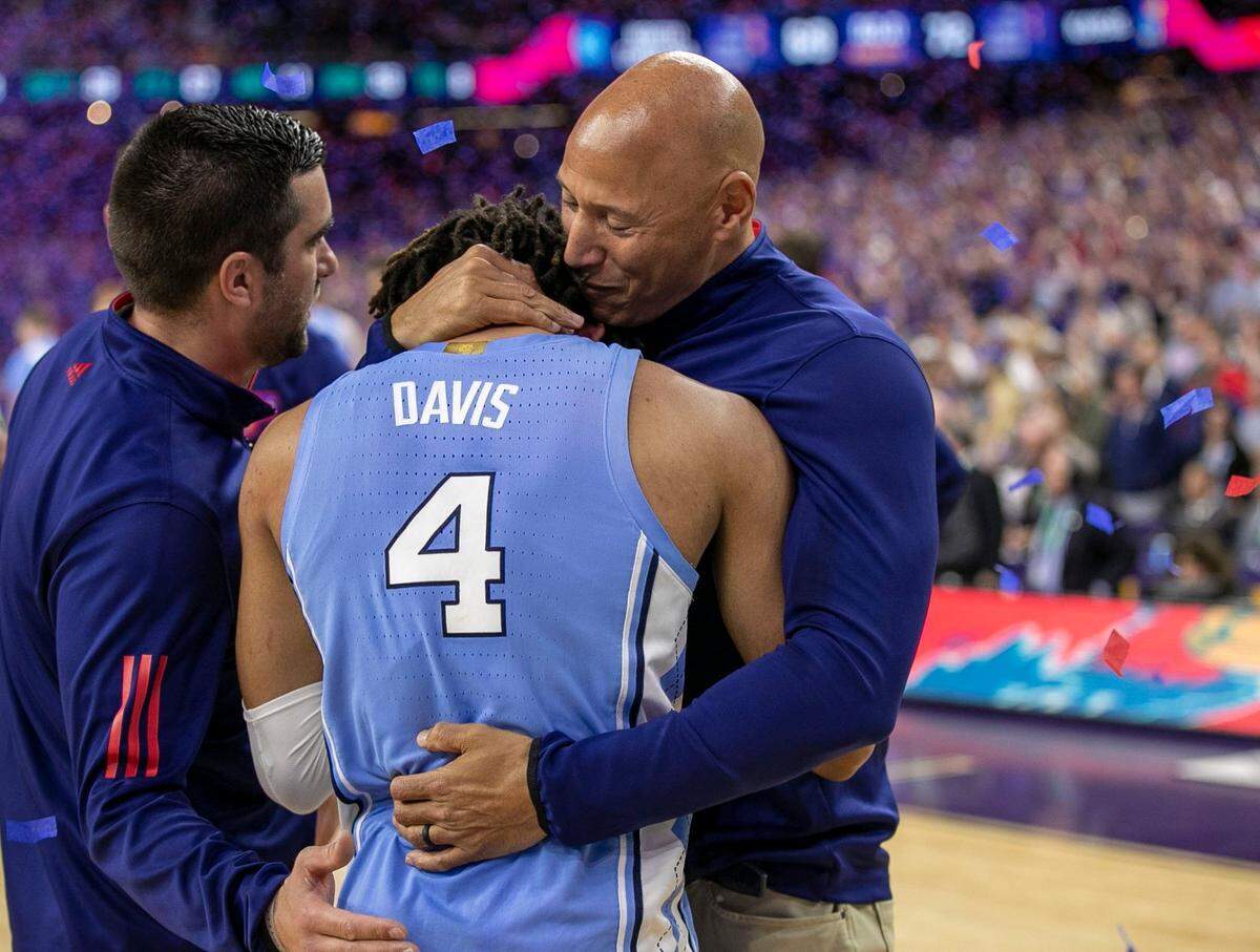 Fred Quartlebaum, Kansas director of basketball operations, right, consoles R.J. Davis (4) following the the Tar Heels 72-69 loss in the NCAA Championship game on Monday, April 4, 2022 at Caesars Superdome in New Orleans, La.