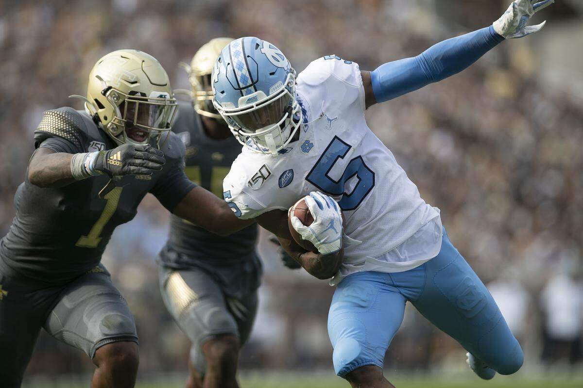 North Carolina’s Dazz Newsome (5) scores on a 20 yard pass completion from quarterback Sam Howell ahead of Georgia TEch’s Juanyeh Thomas (1) to give the Tar Heels a 10-0 lead in the second quarter on Saturday, October 5, at Bobby Dodd Stadium in Atlanta, Georgia.