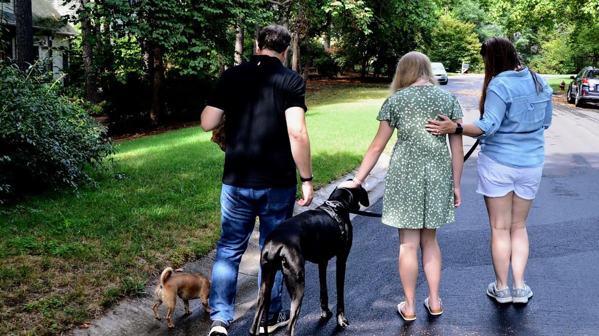 Marie and her parents take their dogs on a walk through their Durham neighborhood. Marie says her dogs are therapeutic for her.