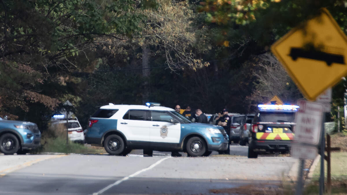 Law enforcement officers, including Raleigh police and NC State police gather at the scene on Trailwood Drive after shots were fired into a car Thursday near Interstate 40 and NC State’s Centennial Campus close to where Raleigh police were already investigating similar reports along the interstate this week.