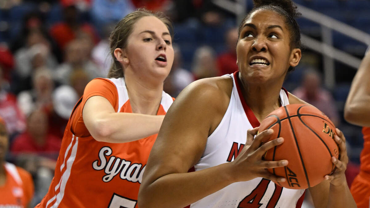 N.C. State’s Camille Hobby sinks a basket over Syracuse’s Georgia Woolley in the Wolfpack’s 83-58 win over Syracuse in the second round of the ACC Women’s Basketball Tournament, Thursday, March 2, 2023. (Walt Unks/Winston-Salem Journal)