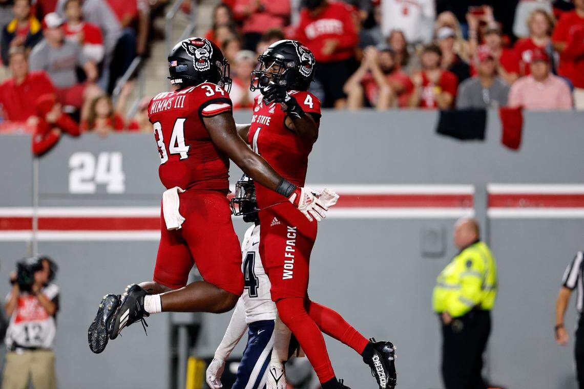 North Carolina State’s Porter Rooks (4) celebrates his touchdown with teammate Delbert Mimms III (34) during the first half of an NCAA college football game in Raleigh, N.C., Saturday, Sept. 24, 2022.