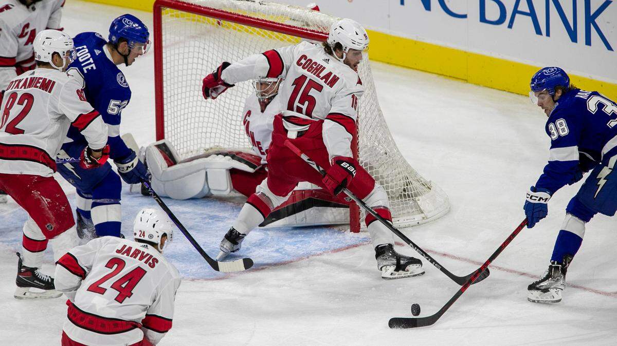 Carolina Hurricanes’ Dylan Coghlan (15) defends Tampa Bay’s Brandon Hegel (38) during the third period of an NHL preseason game against Tampa Bay on Tuesday, September 27, 2022 at PNC Arena in Raleigh, N.C.