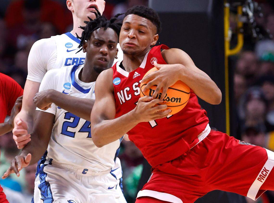 N.C. State’s Casey Morsell (14) pulls in the rebound from Creighton’s Arthur Kaluma (24) during the second half of Creighton’s 72-63 victory over N.C. State in the first round of the NCAA Tournament at Ball Arena in Denver, Colo., Friday, March 17, 2023.