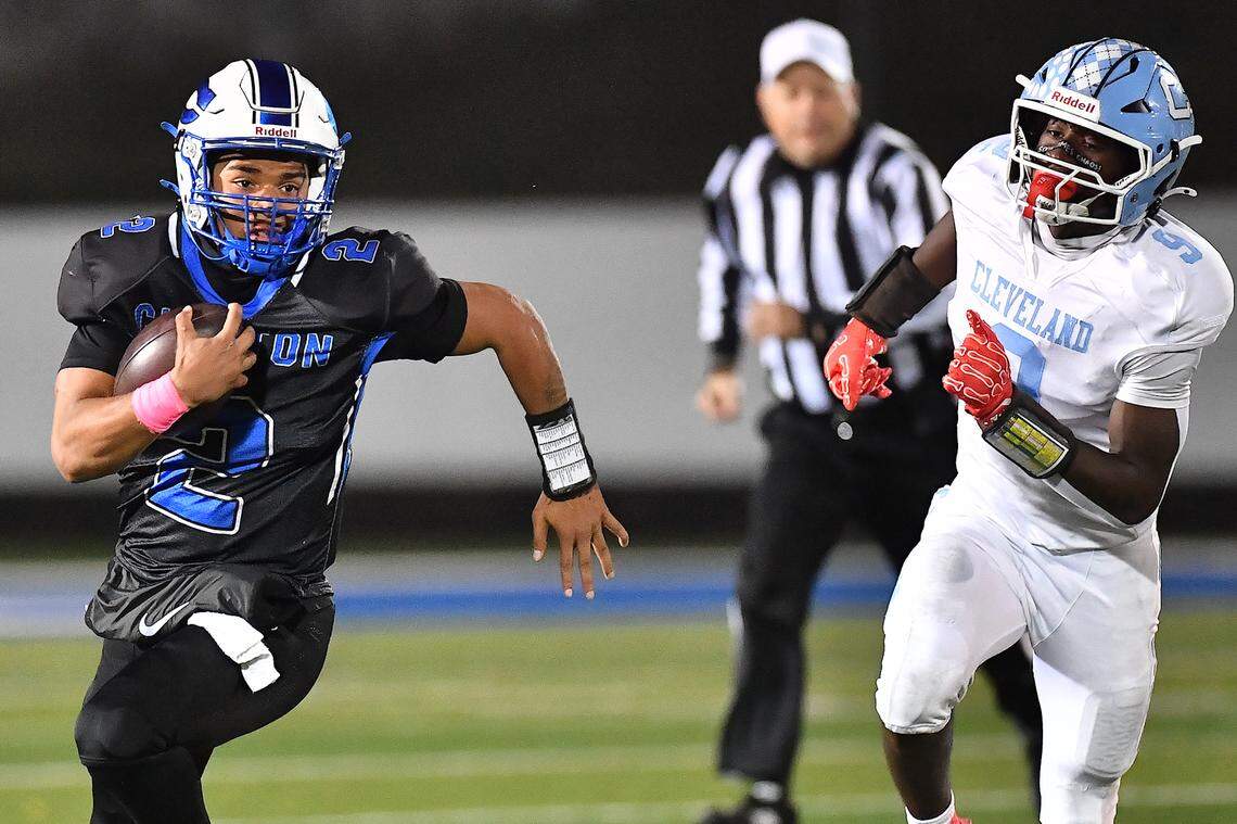 Clayton quarterback (2) sprints for yardage ahead of Cleveland's Jaylen King (9) during the second half. The Cleveland Rams took on the Clayton Comets in a conference football game in Clayton, N.C. on October 31st in Clayton, N.C.