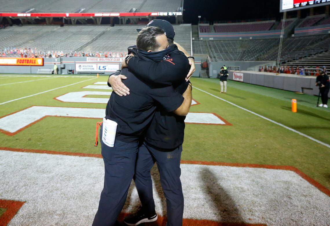 N.C. State offensive coordinator Tim Beck, left, hugs offensive line coach John Garrison after N.C. State’s 45-42 victory over Wake Forest at Carter-Finley Stadium in Raleigh, N.C, Saturday, Sept. 19, 2020.