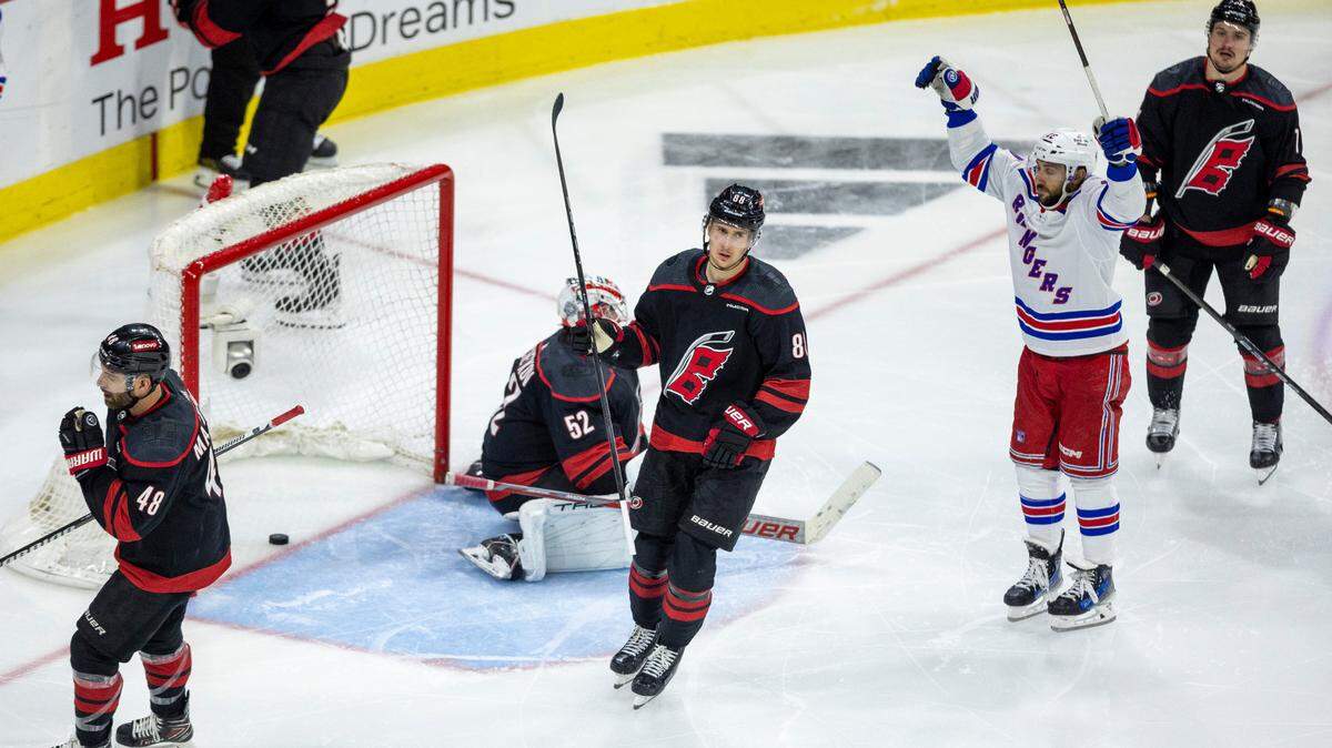 Carolina Hurricanes center Martin Necas (88), and New York Rangers center Vincent Trocheck (16) react after the game winning goal in overtime by New York Rangers left wing Artemi Panarin (10), securing a 3-2 victory in Game 3 during the second round of the 2024 Stanley Cup playoffs on Thursday, May 9, 2024 at PNC Arena, in Raleigh N.C.