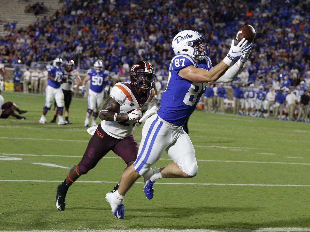 Duke’s Noah Gray (87) catches a touchdown pass while Virginia Tech’s Reggie Floyd chases during the first half of an NCAA college football game in Durham, N.C., Saturday, Sept. 29, 2018.