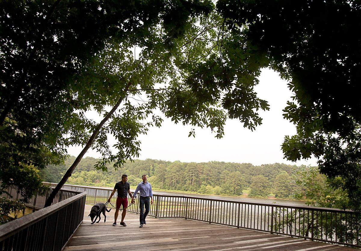 Jose Chavira and Alfred Harvey of Raleigh at Shelley Lake with their dog, Elsa, in a July 2015 file photo.