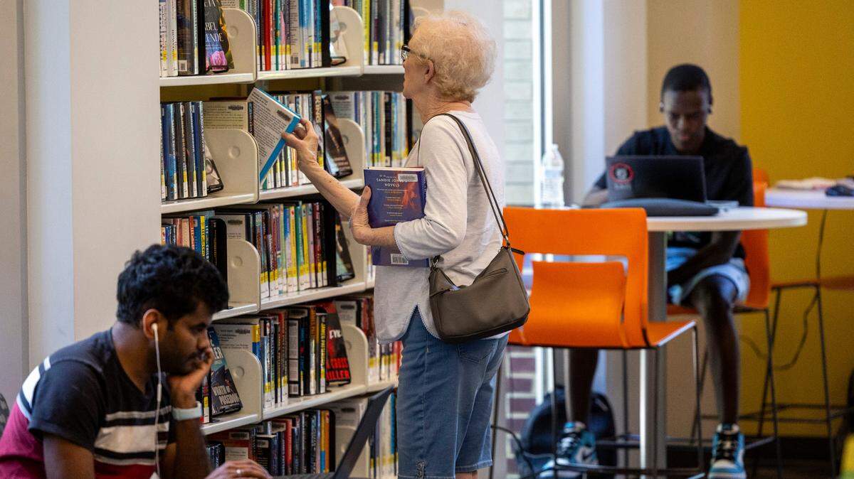 From left, Naga Kopparapu, Jeri Lewis and Alusine Kamara use the Green Road Library in Raleigh on Tuesday, May 22, 2024.